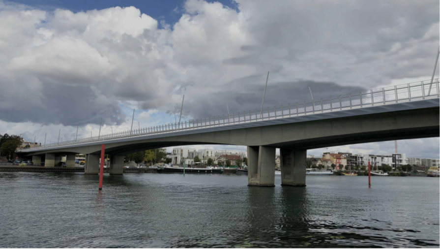 Le pont vu depuis la Seine, avec ses candélabres d'éclairage inclinés au-dessus des voies